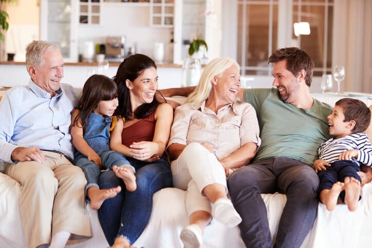 Three generations of a family relaxing together at home